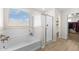 Bright bathroom with a soaking tub, glass-enclosed shower, and modern fixtures for a spa-like experience at 18381 W La Senda Dr, Surprise, AZ 85387