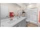 Bathroom featuring dual vanities, a walk-in shower with glass doors, and modern fixtures at 18381 W La Senda Dr, Surprise, AZ 85387
