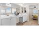 Bathroom featuring dual sinks, bright lighting and mirrors for a modern look at 18381 W La Senda Dr, Surprise, AZ 85387