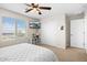 Tranquil bedroom featuring neutral tones, a ceiling fan, and natural light from a window at 18381 W La Senda Dr, Surprise, AZ 85387