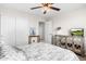 Bright bedroom featuring a ceiling fan, mirrored cabinet, and stylish decor for a cozy and inviting ambiance at 18381 W La Senda Dr, Surprise, AZ 85387