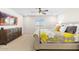 Bright bedroom featuring a window, plush bedding, a dresser and tv for a relaxing atmosphere at 18381 W La Senda Dr, Surprise, AZ 85387
