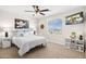 Serene bedroom with neutral décor, featuring a quilted bed and bright natural light at 18381 W La Senda Dr, Surprise, AZ 85387