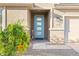 Eye-catching front door with glass panels, complemented by desert landscaping at 18381 W La Senda Dr, Surprise, AZ 85387