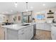Bright kitchen features a large island with quartz countertops, white cabinetry, and stainless steel appliances at 18381 W La Senda Dr, Surprise, AZ 85387