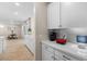 Clean and bright kitchen features white cabinets, quartz countertops, and a gray tile backsplash at 18381 W La Senda Dr, Surprise, AZ 85387