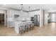 Bright, modern kitchen featuring a large island, white cabinets, and stainless steel appliances at 18381 W La Senda Dr, Surprise, AZ 85387
