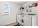 Well-lit laundry room with modern appliances and storage shelves at 18381 W La Senda Dr, Surprise, AZ 85387