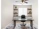 Inviting home office featuring built-in storage, modern desk, and lots of natural light at 18381 W La Senda Dr, Surprise, AZ 85387