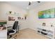 Functional home office with a built-in desk, shelving, and plenty of natural light at 18381 W La Senda Dr, Surprise, AZ 85387