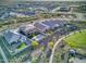 An aerial view shows the backyard of a property including a pool with lounge chairs, a barbeque, and a grassy area at 18381 W La Senda Dr, Surprise, AZ 85387