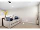 Comfortable sitting area in neutral tones with a sofa and decorative pillows at 18381 W La Senda Dr, Surprise, AZ 85387