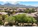 Scenic aerial view of homes in desert community with mountain backdrop and lush desert landscaping at 19777 N 76Th St # 1106, Scottsdale, AZ 85255