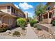 Landscaped exterior of townhouse featuring a walkway and flowering plants at 19777 N 76Th St # 1106, Scottsdale, AZ 85255