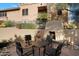 Community outdoor seating area with a stucco fireplace, comfortable seating, and mature landscaping at 19777 N 76Th St # 1106, Scottsdale, AZ 85255