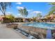 Community pool featuring a cascading water feature, surrounding lounge chairs, and lush landscaping at 19777 N 76Th St # 1106, Scottsdale, AZ 85255