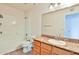 Bright bathroom boasts a tub and shower combination and a vanity with granite countertops at 2025 E Campbell Ave # 248, Phoenix, AZ 85016