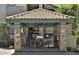 Outdoor kitchen, dining table, and ceiling fan make this cabana perfect for poolside entertainment at 2025 E Campbell Ave # 248, Phoenix, AZ 85016