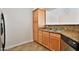 Kitchen with wood cabinets, granite countertops and dishwasher at 2025 E Campbell Ave # 248, Phoenix, AZ 85016