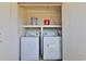 A laundry closet has a washing machine and dryer with shelf above it at 2025 E Campbell Ave # 248, Phoenix, AZ 85016