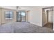 Bright living room with carpet floors, a ceiling fan, and a sliding glass door to the balcony at 2025 E Campbell Ave # 248, Phoenix, AZ 85016