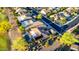 Aerial view showcasing a home with a private pool, lush landscaping, and proximity to a golf course and neighborhood streets at 20558 N 263Rd Dr, Buckeye, AZ 85396