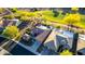 Drone view of a home featuring a swimming pool, desert landscaping, and close proximity to a golf course at 20558 N 263Rd Dr, Buckeye, AZ 85396