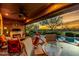 Covered outdoor patio with fireplace, comfortable seating, and views of the pool at 20558 N 263Rd Dr, Buckeye, AZ 85396