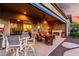 Covered back patio with ample seating and a fireplace perfect for outdoor entertaining at 20558 N 263Rd Dr, Buckeye, AZ 85396