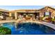 Outdoor living at its finest with a pool, hot tub, covered patio, and lush landscaping at 20558 N 263Rd Dr, Buckeye, AZ 85396