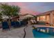 Serene backyard oasis with a pool, spa, lounge chairs, and meticulous landscaping perfect for outdoor living at 20558 N 263Rd Dr, Buckeye, AZ 85396
