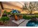 Desert backyard with lounge chairs, dining area, and a view of the pool at 20558 N 263Rd Dr, Buckeye, AZ 85396