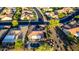 Aerial view of backyard features a sparkling private pool, spa, and covered patio in a lushly landscaped neighborhood at 20558 N 263Rd Dr, Buckeye, AZ 85396