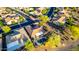 Aerial view of backyard features a sparkling private pool, spa, and covered patio in a lushly landscaped neighborhood at 20558 N 263Rd Dr, Buckeye, AZ 85396