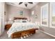 Cozy bedroom with wood furniture, ceiling fan, and bright natural light from the shuttered window at 20558 N 263Rd Dr, Buckeye, AZ 85396