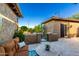 Inviting outdoor patio with a comfortable couch and table with a view of the desert landscaping at 20558 N 263Rd Dr, Buckeye, AZ 85396