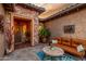 Inviting courtyard featuring flagstone, outdoor seating, and desert plants at 20558 N 263Rd Dr, Buckeye, AZ 85396