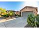 A beautiful desert home with driveway and two car garage complemented by native desert landscaping at 20558 N 263Rd Dr, Buckeye, AZ 85396