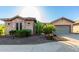 Desert home with a two car garage and native landscaping, including cacti and desert plants at 20558 N 263Rd Dr, Buckeye, AZ 85396