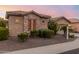 Charming home exterior with stone accents, desert landscaping and a lush, green lawn at 20558 N 263Rd Dr, Buckeye, AZ 85396