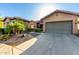Beautiful desert home with a well-manicured lawn and attached two-car garage at 20558 N 263Rd Dr, Buckeye, AZ 85396