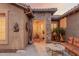 Inviting front entrance with stone accents, a covered porch, and a seating area for welcoming guests at 20558 N 263Rd Dr, Buckeye, AZ 85396