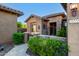 Charming front entrance with stone accents, a welcoming doorway, and lush desert landscaping at 20558 N 263Rd Dr, Buckeye, AZ 85396