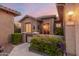 Inviting front entrance featuring stone accents, a gated walkway, and mature landscaping at 20558 N 263Rd Dr, Buckeye, AZ 85396