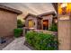 Charming front entrance with stone accents and desert landscaping with mature plants at 20558 N 263Rd Dr, Buckeye, AZ 85396