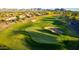 Stunning aerial view of a well-maintained golf course community with lush green fairways and mountain views at 20558 N 263Rd Dr, Buckeye, AZ 85396