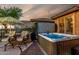 Hot tub provides an intimate backyard with a built-in grill and patio seating, ready for enjoyment at 20558 N 263Rd Dr, Buckeye, AZ 85396