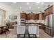 Open kitchen featuring dark wood cabinets, granite counters, and stainless appliances at 20558 N 263Rd Dr, Buckeye, AZ 85396