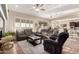 Spacious living room with comfortable seating, plantation shutters, and open access to the kitchen at 20558 N 263Rd Dr, Buckeye, AZ 85396