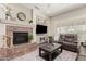 Comfortable living room with a fireplace and built-in shelving at 20558 N 263Rd Dr, Buckeye, AZ 85396